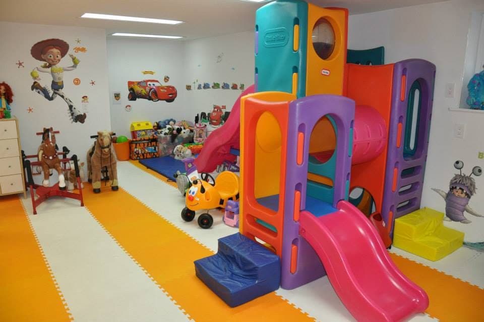 The colorful indoor climbing and slide play structure inside the playhouse