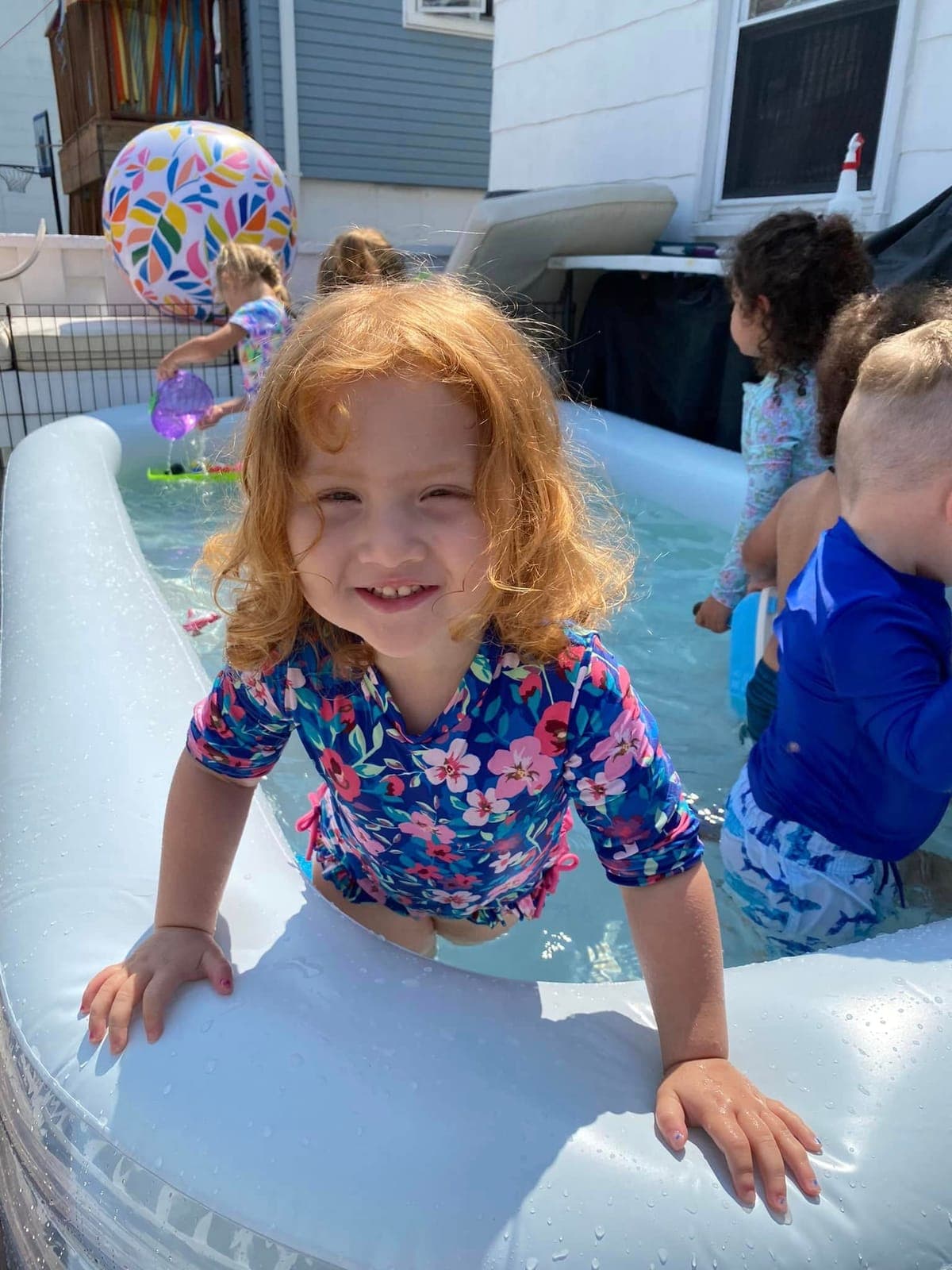 Kids splashing in the backyard pool on a sunny summer day at Kelly's Kidz Playhouse in Rockaway Beach